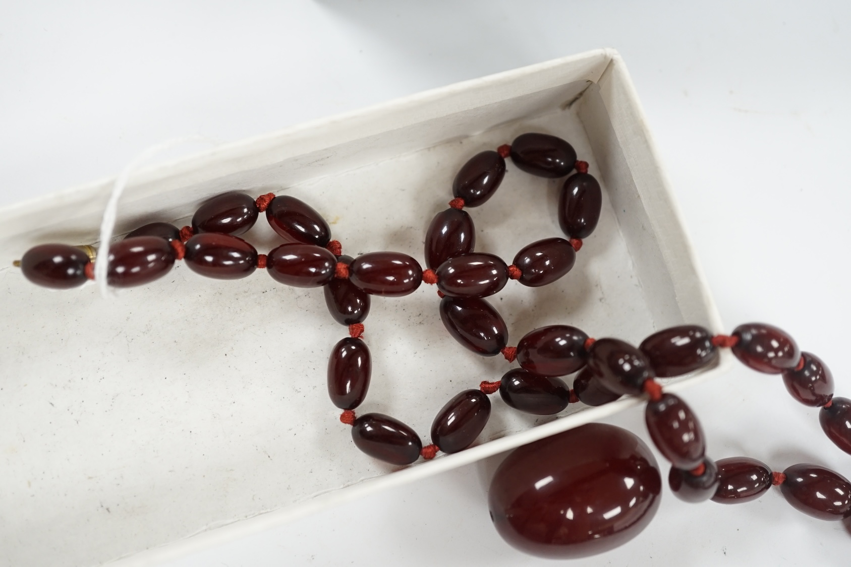 A single strand graduated simulated cherry amber bead necklace, gross weight 66 grams (string a.f.) Condition - poor to fair